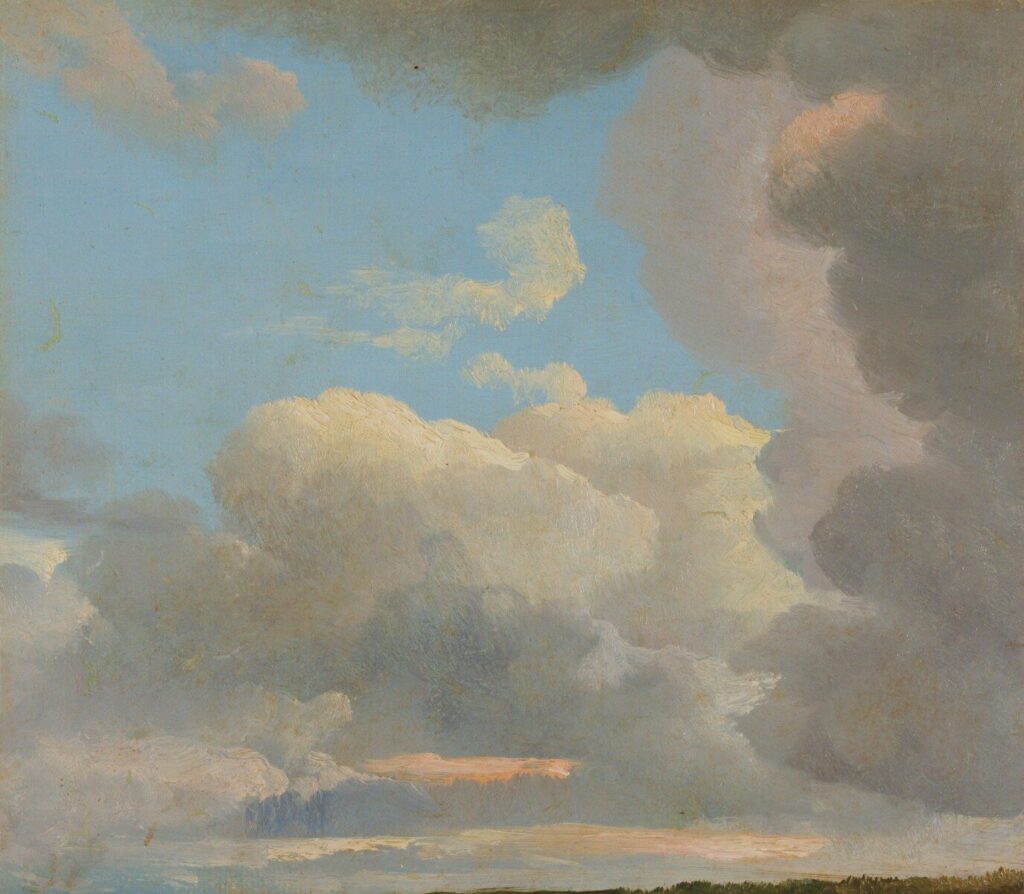 Fluffy white and dark gray clouds in a blue sky
